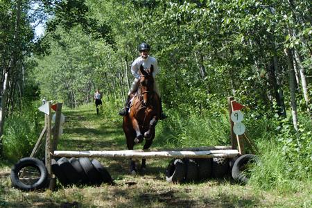 Jenny_riding_Kramer_cross_country.jpg - Jenny riding Kramer on TP cross country course